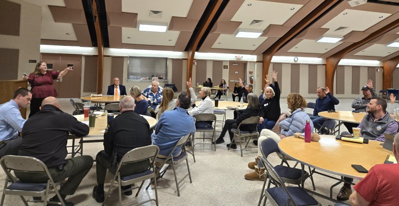 Business owners located around the Bandstand raise their hands in agreement when asked if the city should consider moving Saturday concerts during the summer to mid-week. CHRIS FLOOD PHOTOS